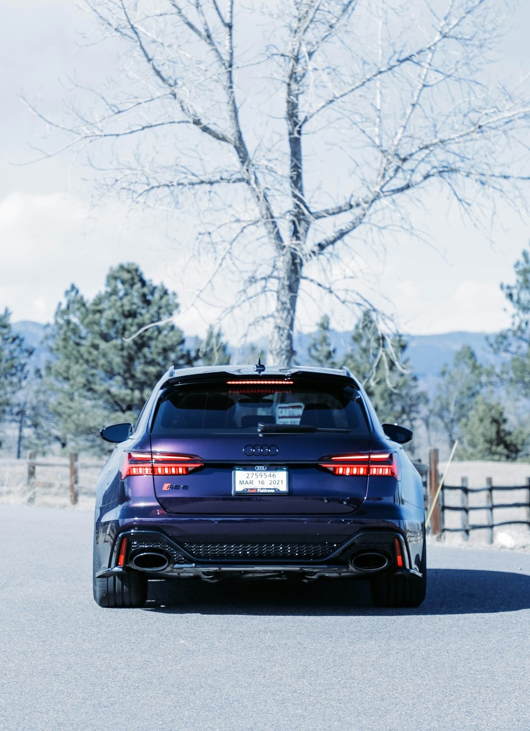 Dark purple Audi RS6 wagon parked on an asphalt road.